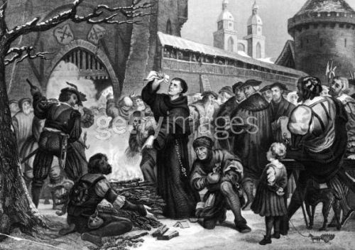Circa 1518, Martin Luther standing before a fire with the work of Johann Tetzel in his hand. Tetzel and Luther wrote theological works arguing with the other's cause, resulting in the public burning of each other's work. Original Artwork: Engraved by Chevalier after (Photo by Hulton Archive/Getty Images)